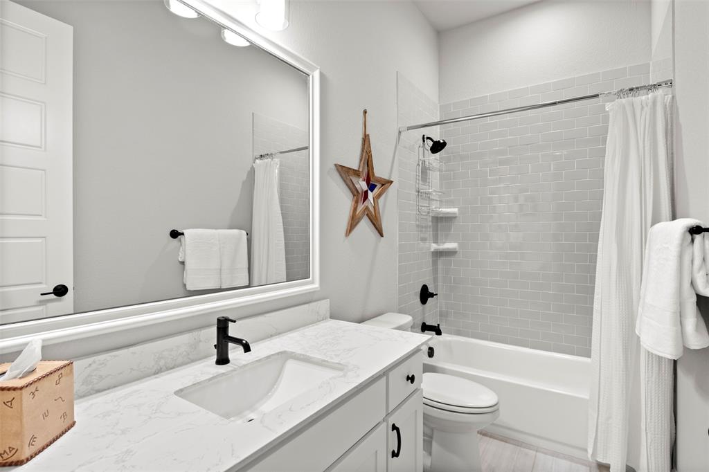 2002 Kati Jane Lane Midlothian, TX 76065 - Photo 15 of 30 a bathroom with a sink a toilet and a mirror