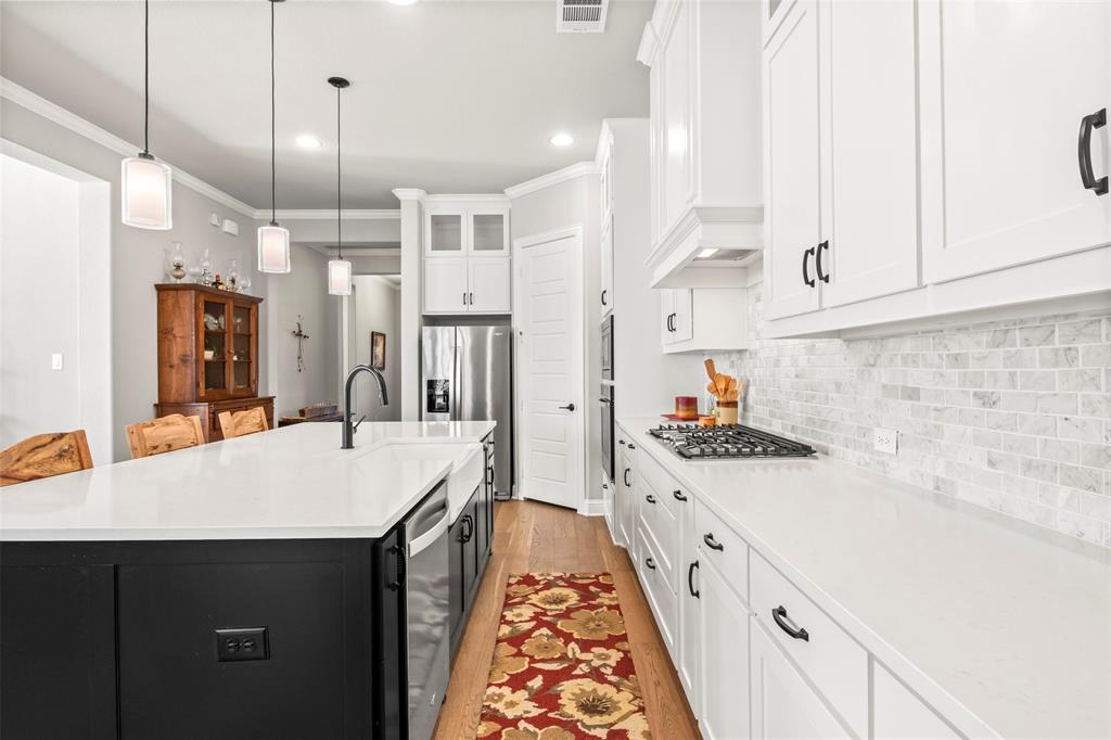 2002 Kati Jane Lane Midlothian, TX 76065 - Photo 21 of 30 a kitchen with kitchen island a sink stove and refrigerator