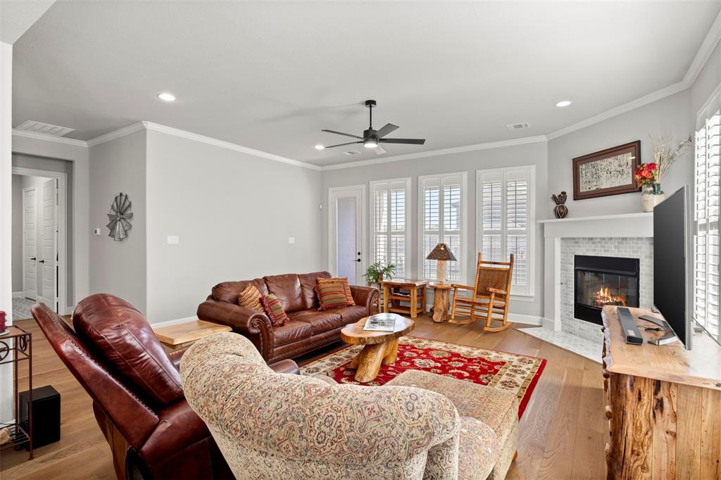 2002 Kati Jane Lane Midlothian, TX 76065 - Photo 23 of 30 a living room with furniture ceiling fan and a fireplace