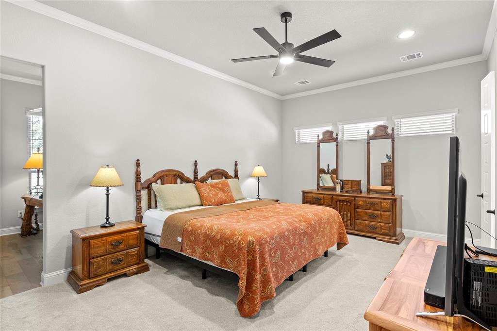 2002 Kati Jane Lane Midlothian, TX 76065 - Photo 6 of 30 a bedroom with a bed a dresser and a chandelier