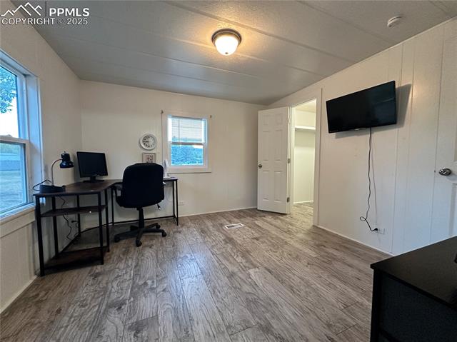 468 Rio Grande Road South Fork, CO 81154 - Photo 27 of 34 Office area with wood finished floors and a decorative wall