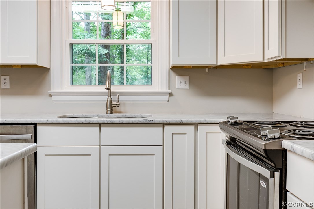 13602 Winterberry Ridge Midlothian, VA 23112 - Photo 14 of 47 a kitchen with granite countertop a sink white cabinets and a window