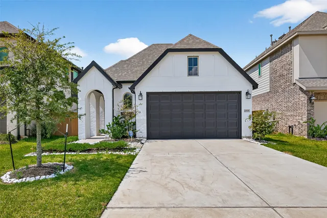 a front view of a house with a yard and garage