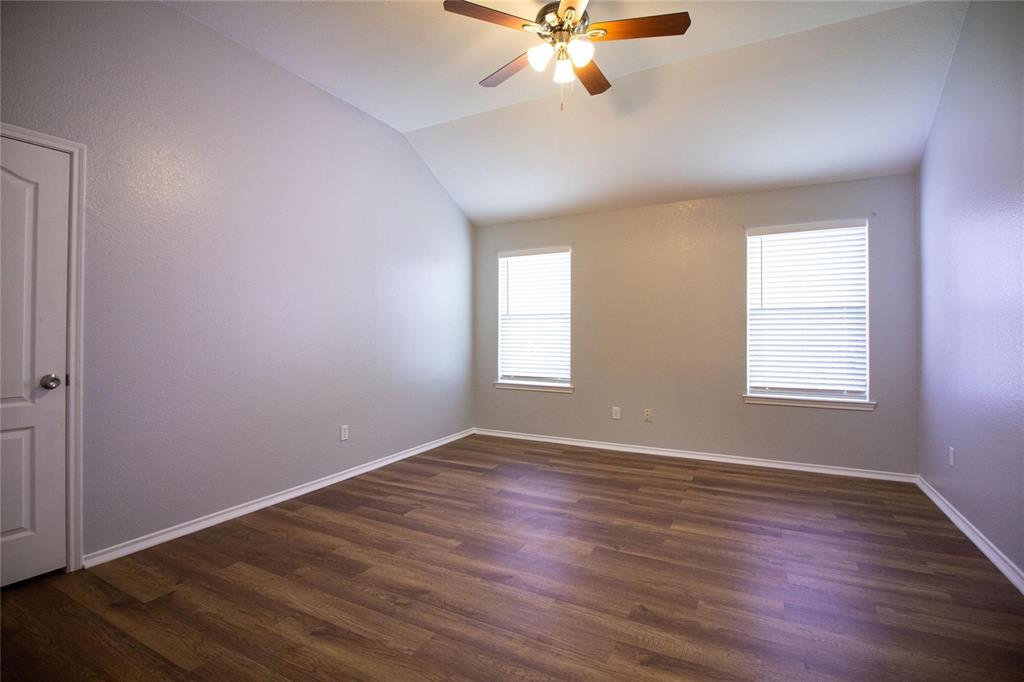 1933 Joe Pool Drive Little Elm, TX 75068 - Photo 12 of 23 a view of an empty room with wooden floor and a window