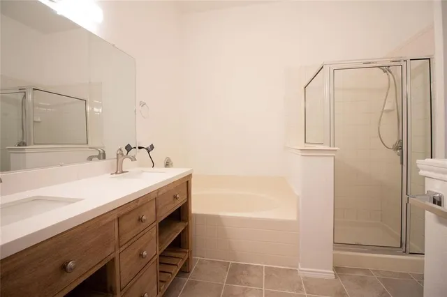 a spacious bathroom with a granite countertop sink mirror and a shower