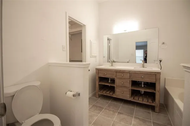 a bathroom with a sink a mirror and a toilet