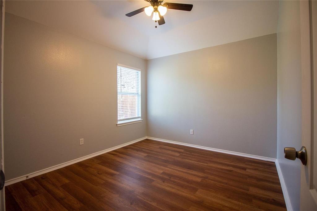 1933 Joe Pool Drive Little Elm, TX 75068 - Photo 16 of 23 a view of a room with wooden floor and a ceiling fan