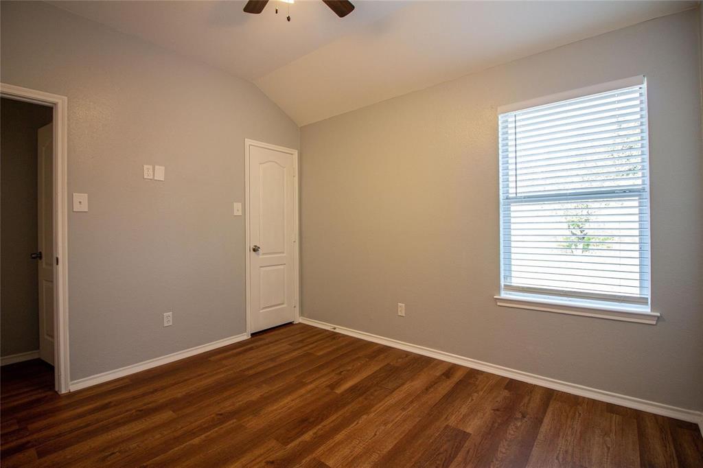 1933 Joe Pool Drive Little Elm, TX 75068 - Photo 17 of 23 a view of an empty room with wooden floor and a window