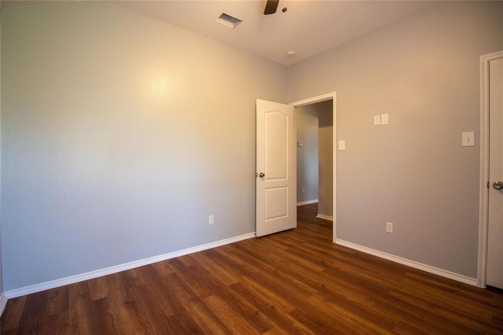1933 Joe Pool Drive Little Elm, TX 75068 - Photo 18 of 23 a view of an empty room with wooden floor