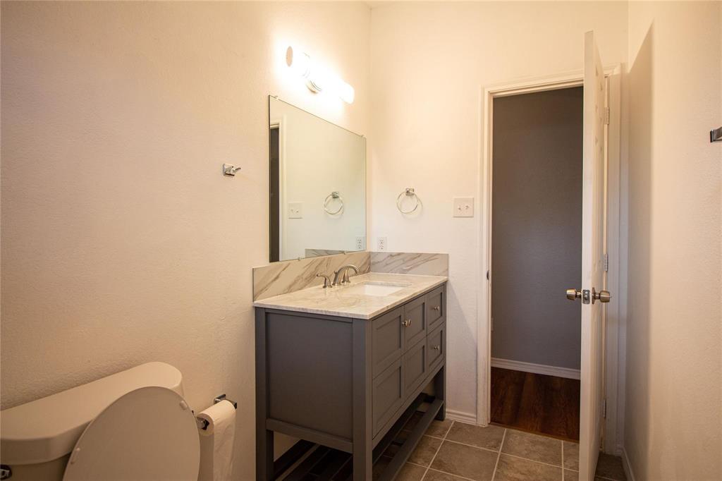 1933 Joe Pool Drive Little Elm, TX 75068 - Photo 19 of 23 a bathroom with a sink toilet and shower