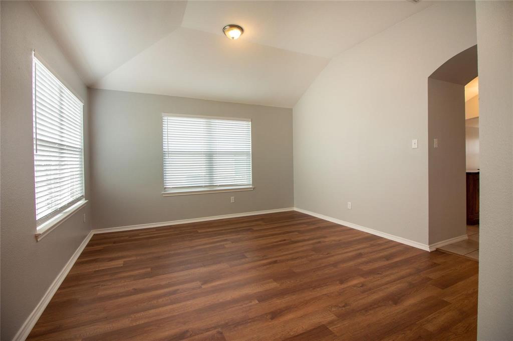 1933 Joe Pool Drive Little Elm, TX 75068 - Photo 4 of 23 an empty room with wooden floor and windows