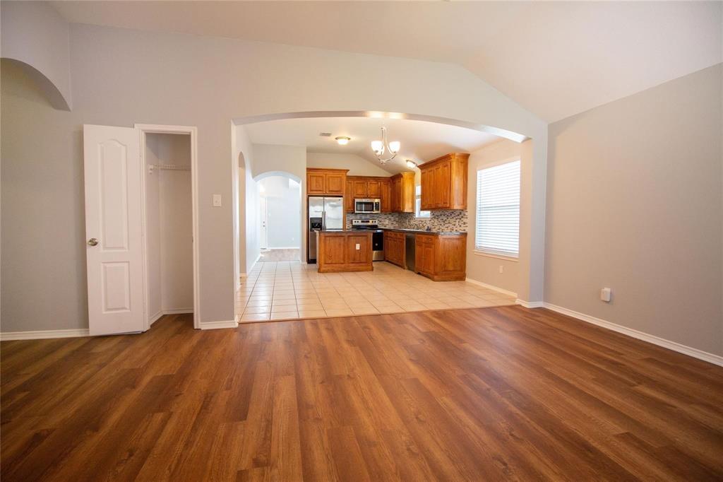 1933 Joe Pool Drive Little Elm, TX 75068 - Photo 23 of 23 a view of a living room a kitchen with wooden floor and a window