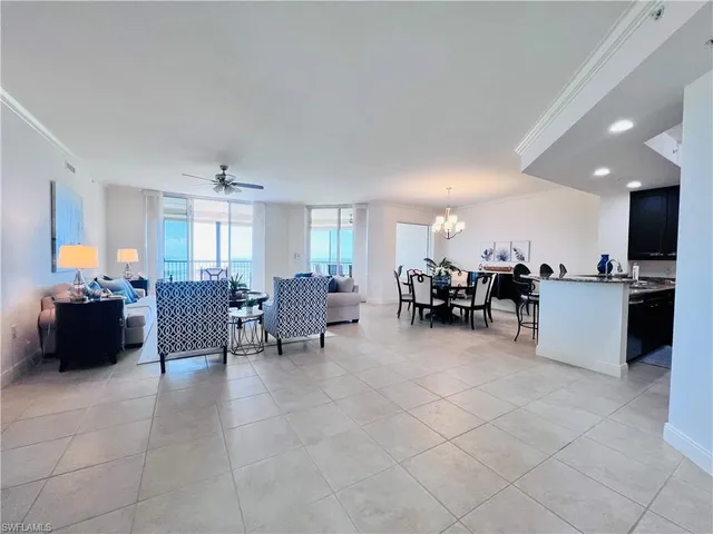 a living room with furniture and a kitchen