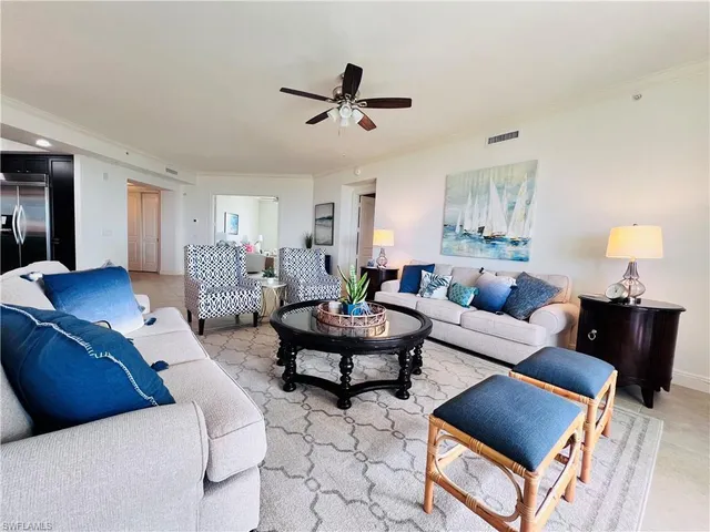 a living room with furniture and a lamp