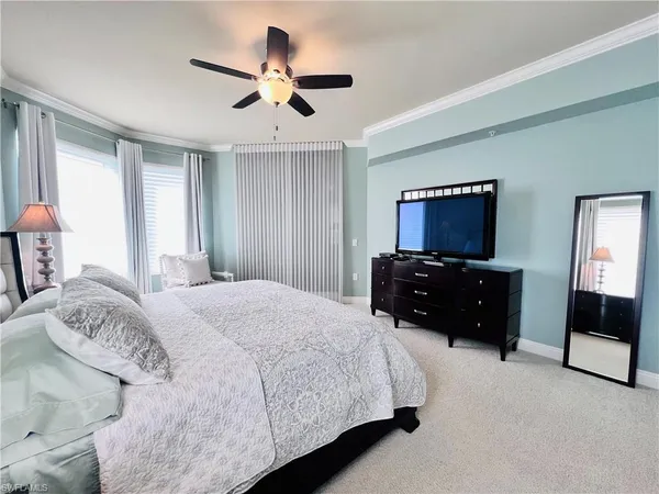 a bedroom with a bed and a television