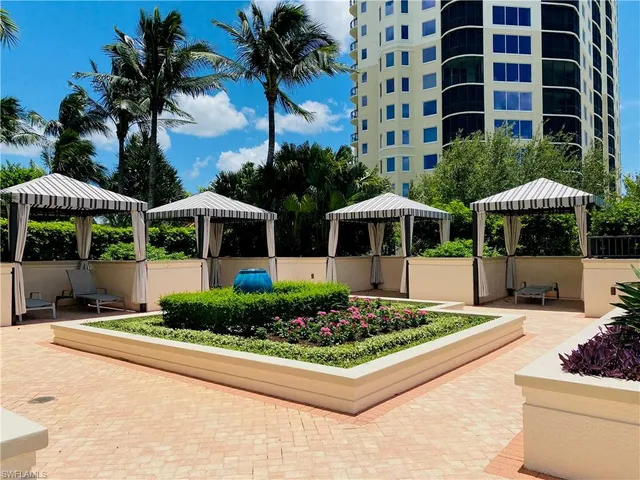 a view of a house with a yard and potted plants