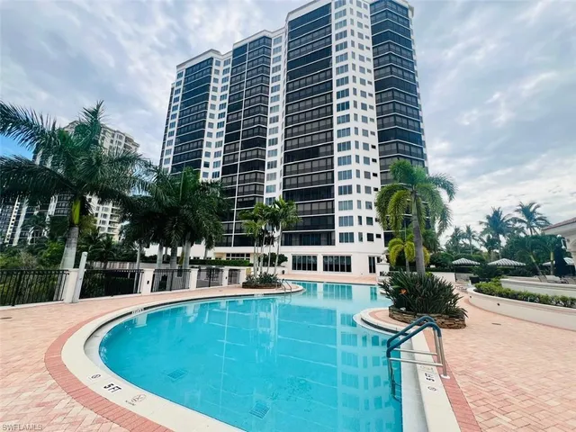 a swimming pool with outdoor seating and yard
