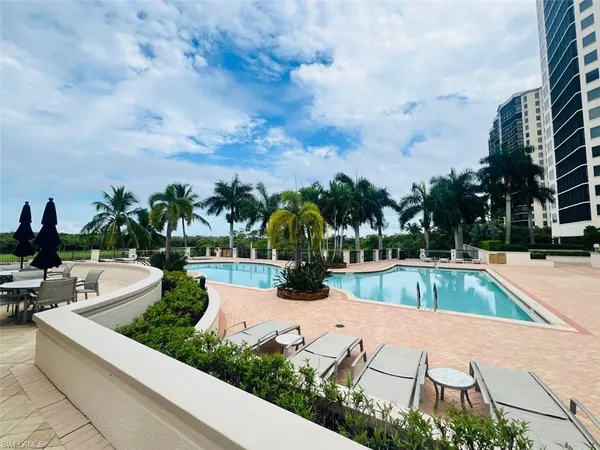 a view of swimming pool with outdoor seating and plants