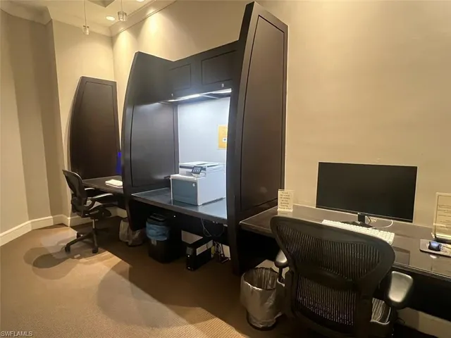 a view of a workspace with furniture and bathroom