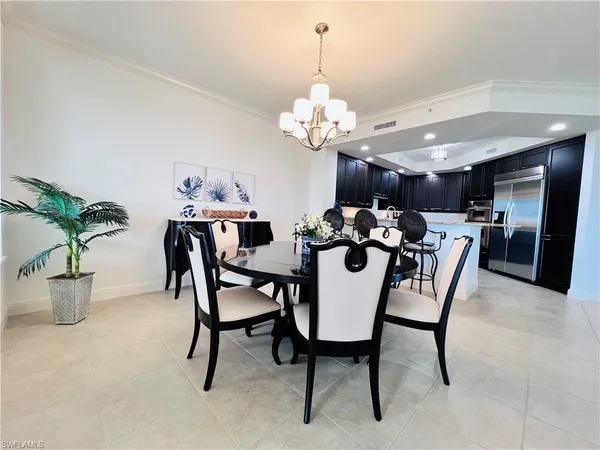 a view of a dining room with furniture and chandelier