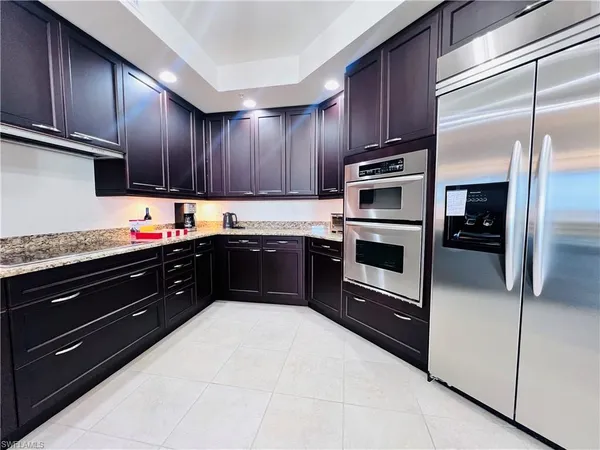 a kitchen with granite countertop stainless steel appliances and wooden cabinets
