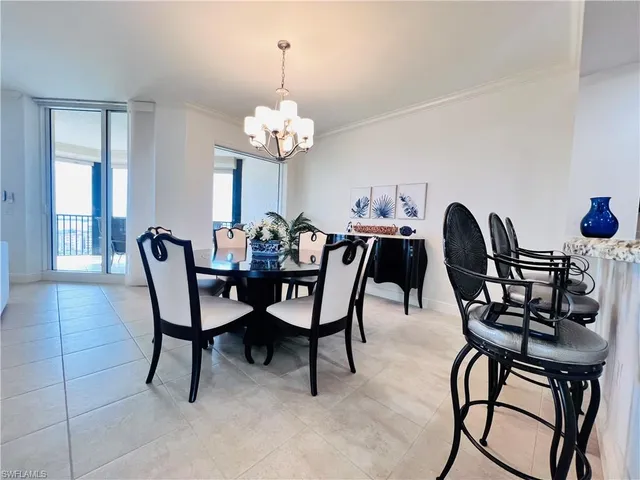 a view of a dining room with furniture and chandelier