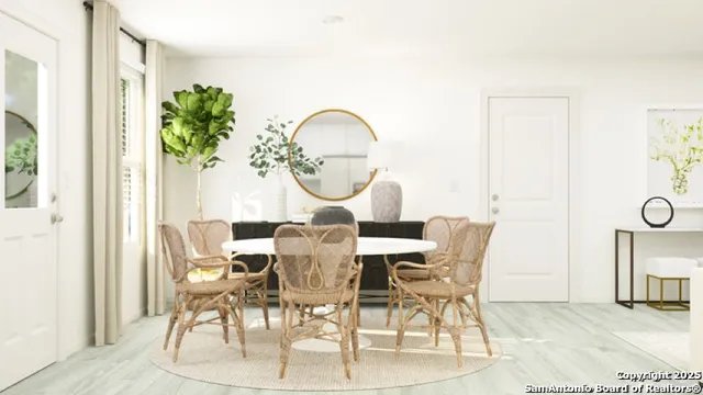 a view of a dining room with furniture and a potted plant