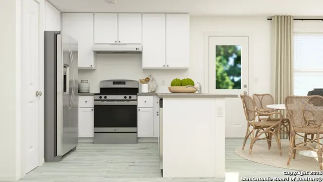 a kitchen with a stove a refrigerator and a table