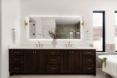 a bathroom with a double vanity sink and mirror