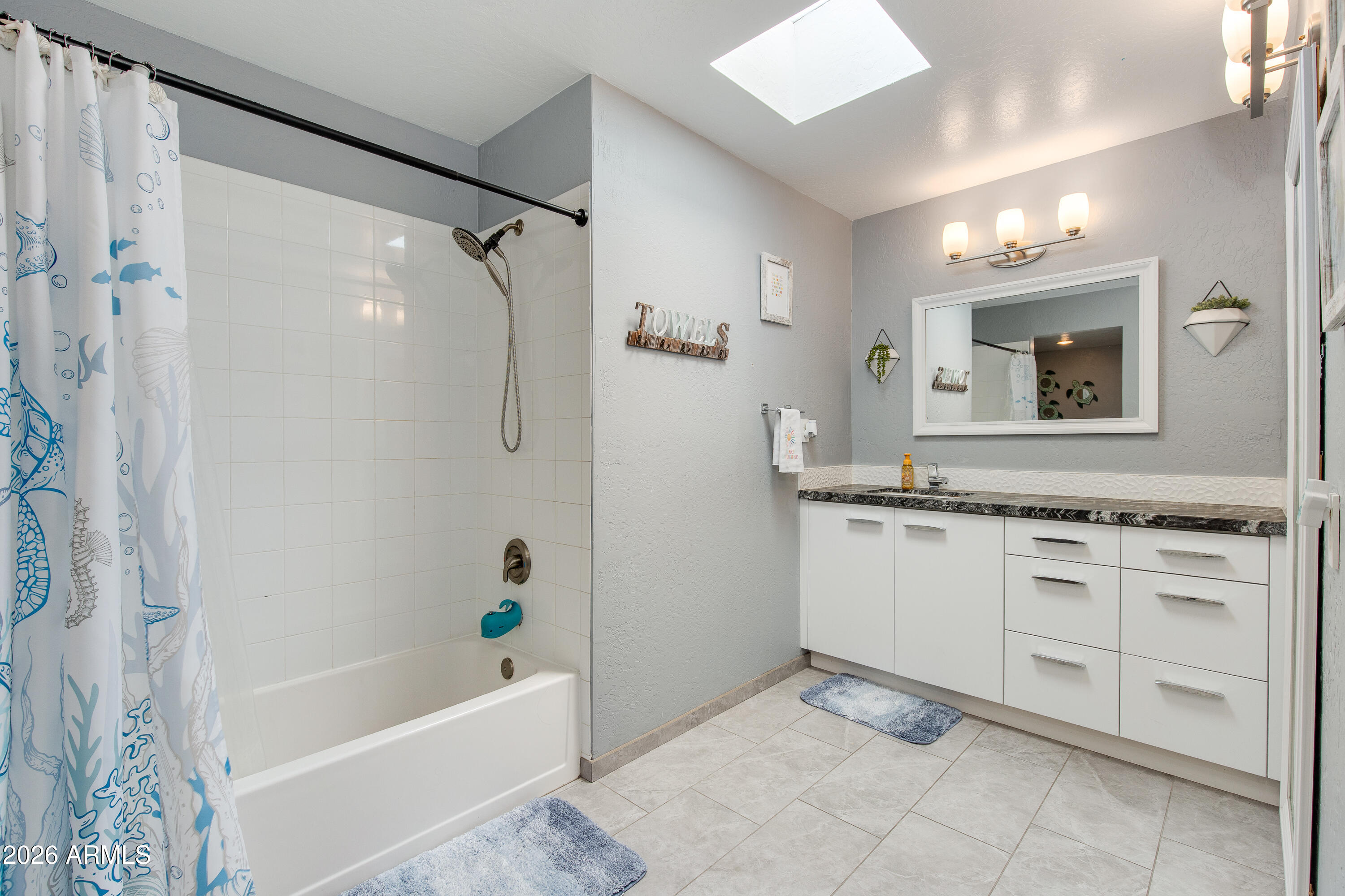 8219 North 3rd Avenue Phoenix, AZ 85021 - Photo 39 of 52 a bathroom with a granite countertop sink a mirror and a bathtub
