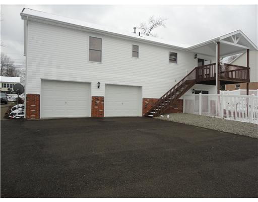 595 Slippery Rock Road Slippery Rock, PA 16057 - Photo 2 of 18 Exterior Back. Extra lge garage gives plenty of room for 2 cars and storage too. Driveway and turnaround area totally paved.Covered deck allows more seasonal use while patio gives more space to relax on