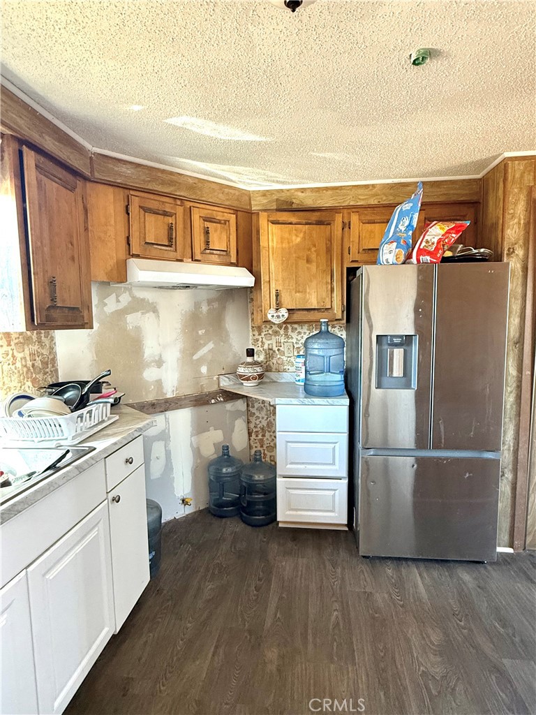 9589 Paramount Road Phelan, CA 92371 - Photo 14 of 29 a kitchen with stainless steel appliances a refrigerator sink and cabinets