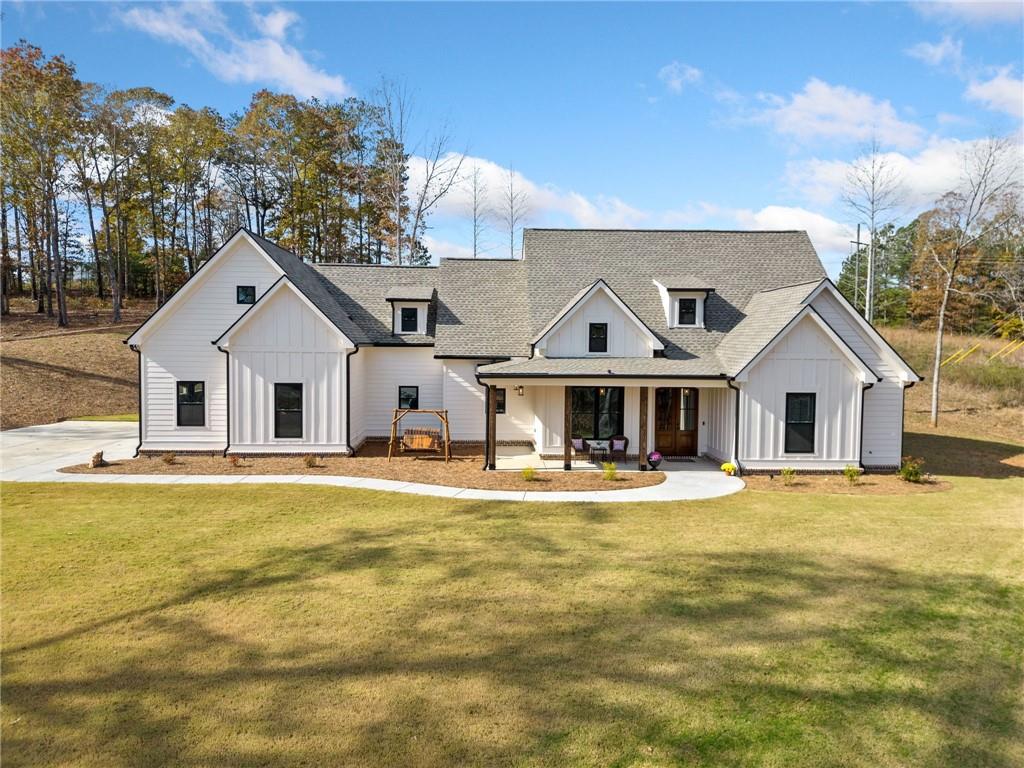 6855 Fincher Road Waleska, GA 30183 - Photo 1 of 1 a view of a white house next to a yard with a large trees