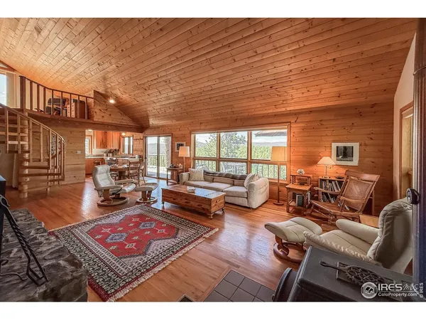 a living room with furniture a rug and a table