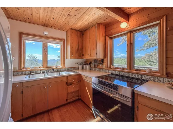 a kitchen that has a sink and a large window