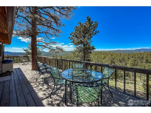 a balcony with table and chairs