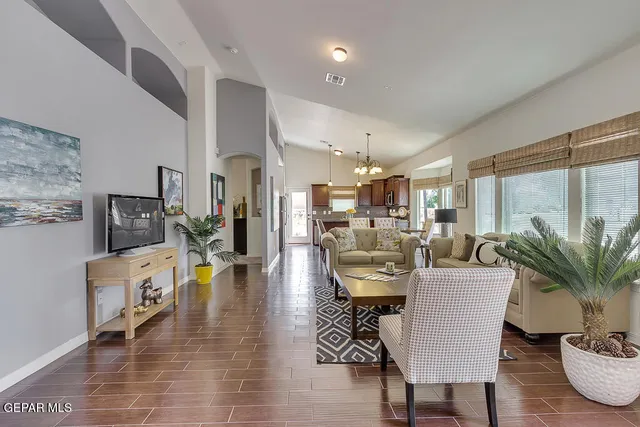 a living room with fireplace furniture and a large window