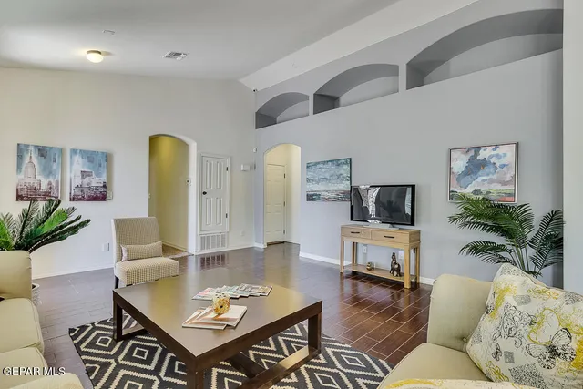 a living room with furniture and wooden floor
