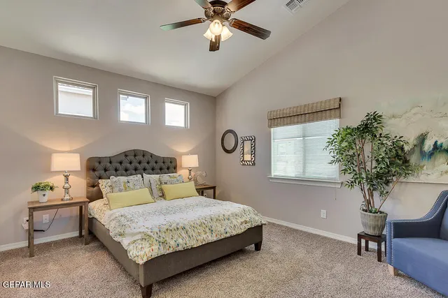 a bedroom with a bed and a chair in it