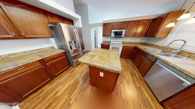a kitchen with stainless steel appliances granite countertop a sink and cabinets