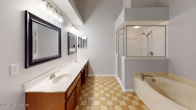 a bathroom with a tub sink and mirror