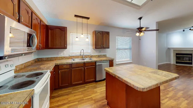 a kitchen with a stove sink and cabinets