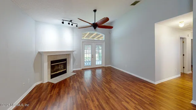 a view of main area fire place window and wooden floor