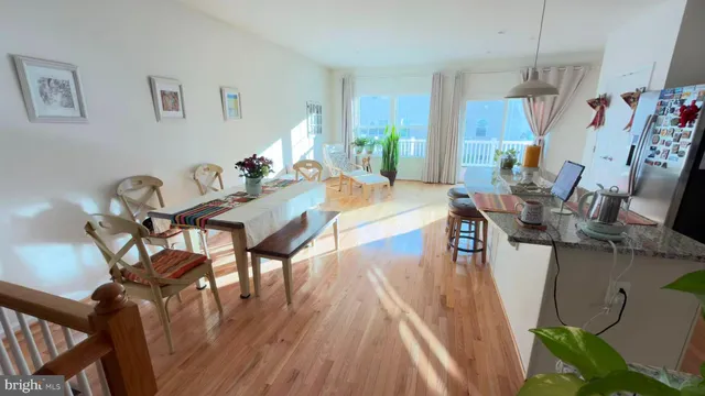 a dining room with furniture a chandelier and wooden floor