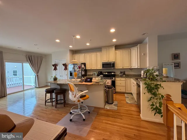 a kitchen with a sink a counter top space and stainless steel appliances