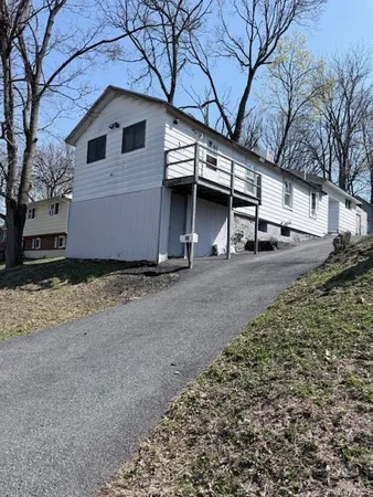 a view of a house with a yard and garage