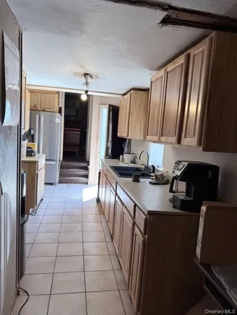 a kitchen with granite countertop a refrigerator and a sink