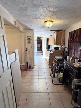 a view of a kitchen with fridge and dining table