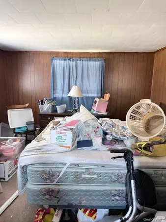 a bed room with two bed and a chair