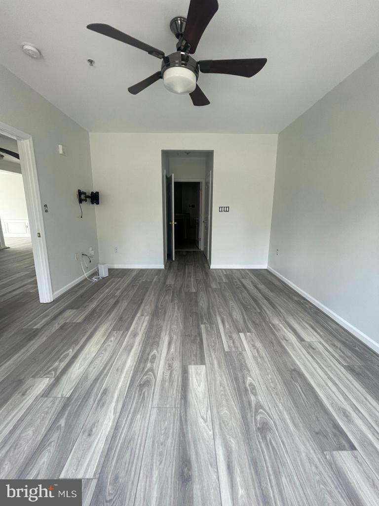 9713 Handerson Place, Unit 304 Manassas Park, VA 20111 - Photo 12 of 14 wooden floor in an empty room with a fireplace